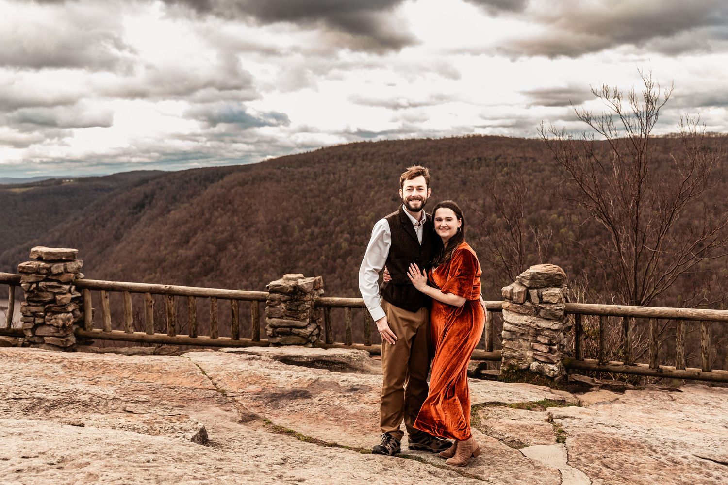 WV engaged couple smile at Coopers Rock State Park