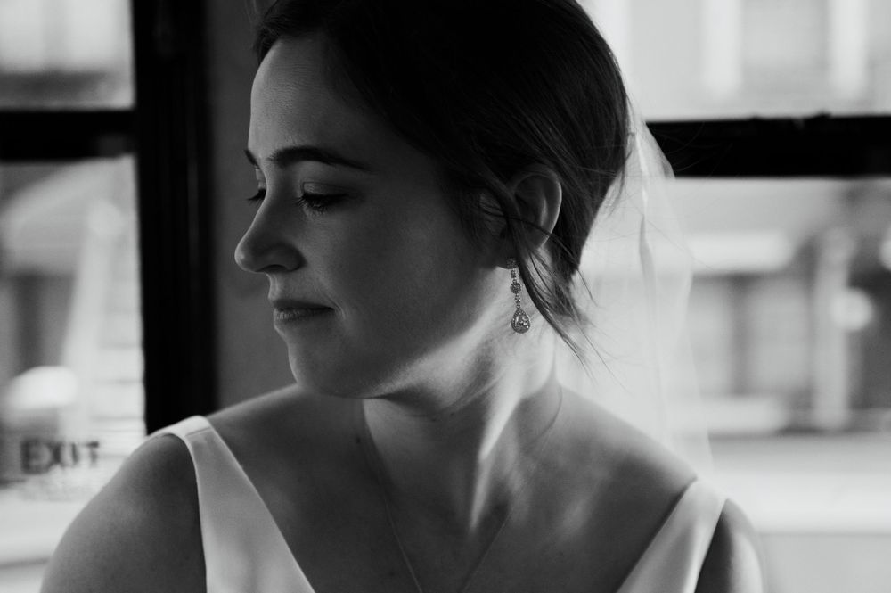 A black and white profile portrait capturing a serene bridal moment.