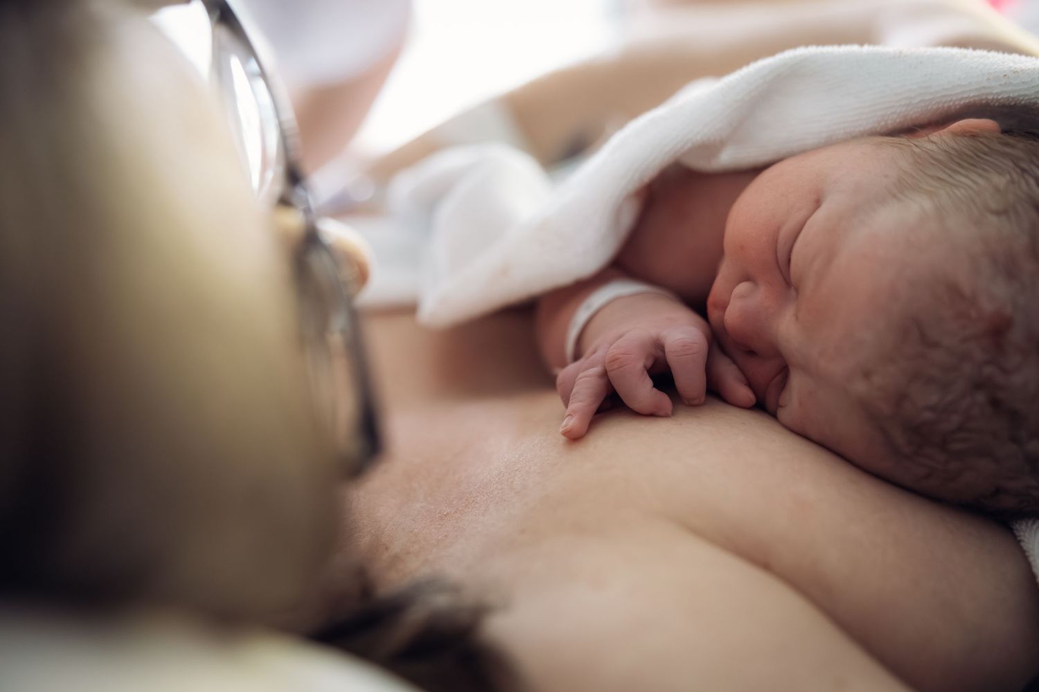 Newborn baby laying on moms chest. Birth Photographer Cape Town By Grace Photography