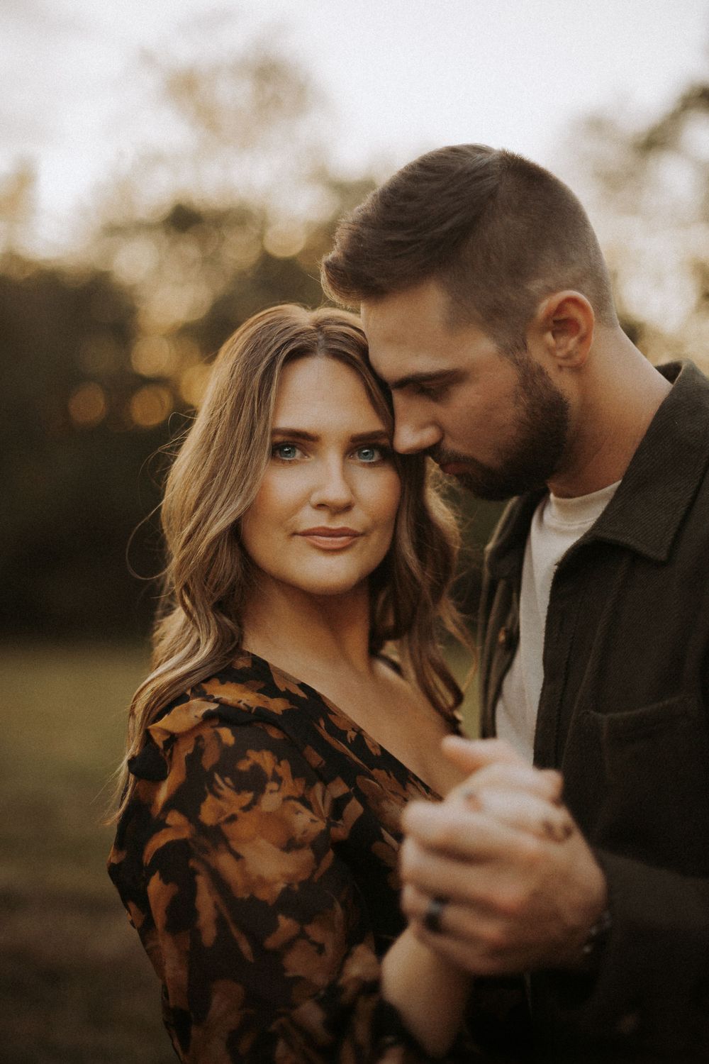 Romantic golden hour portrait of a couple in intimate embrace.
