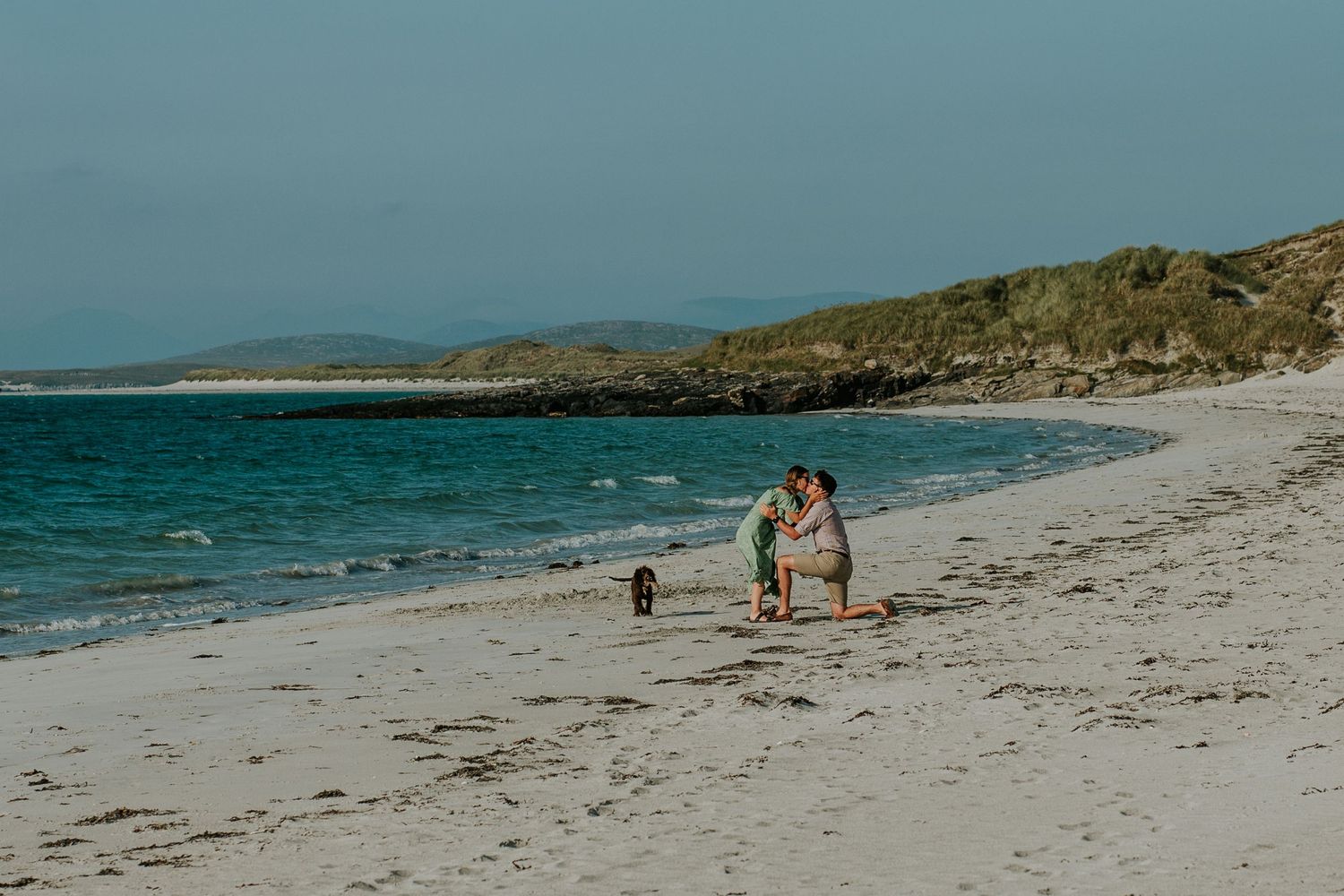 A couple get engaged and kiss on Clachan Sands beach in North Uist during a surprise proposal.