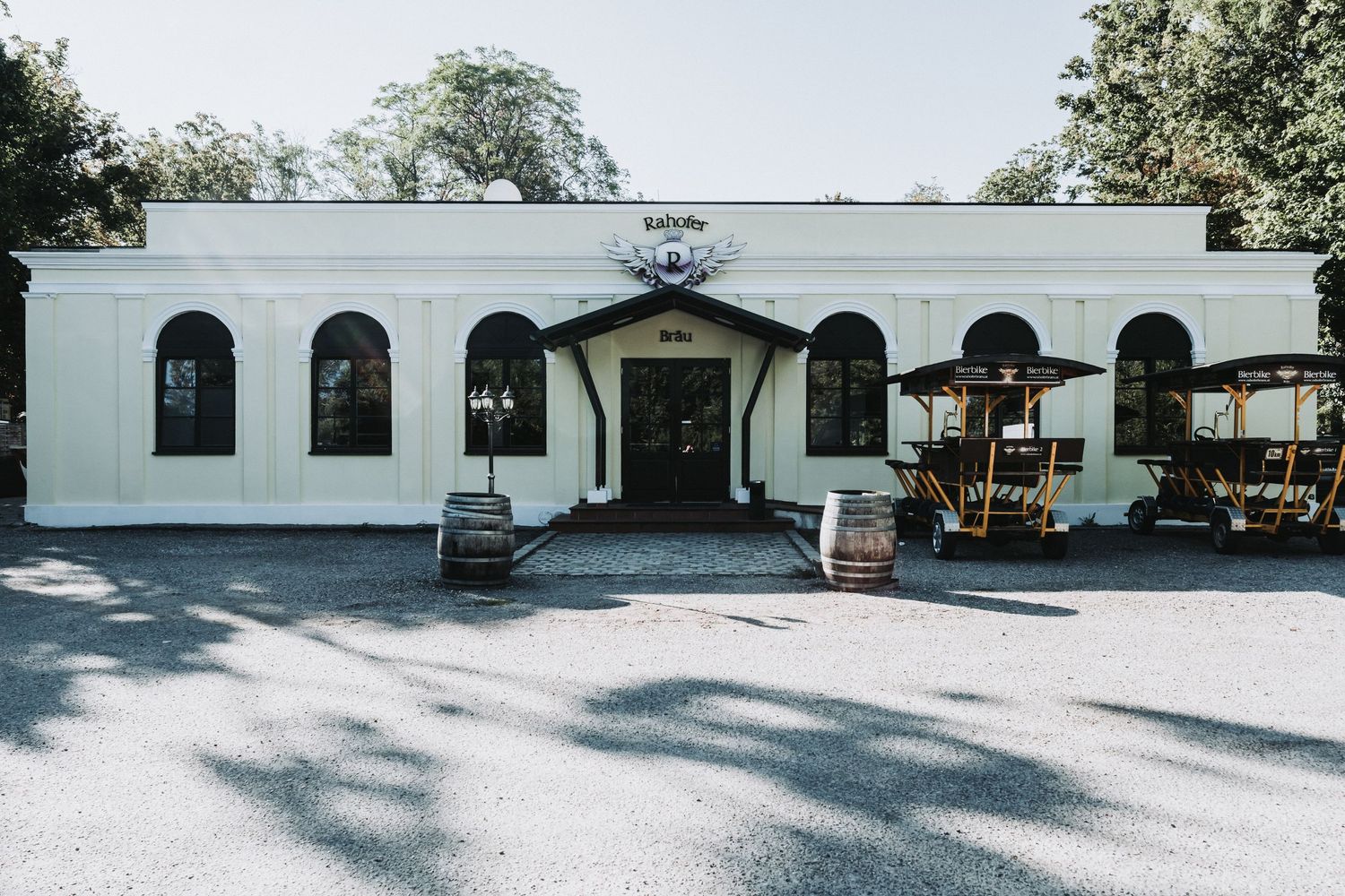 White stucco building with arched windows and entrance doors.