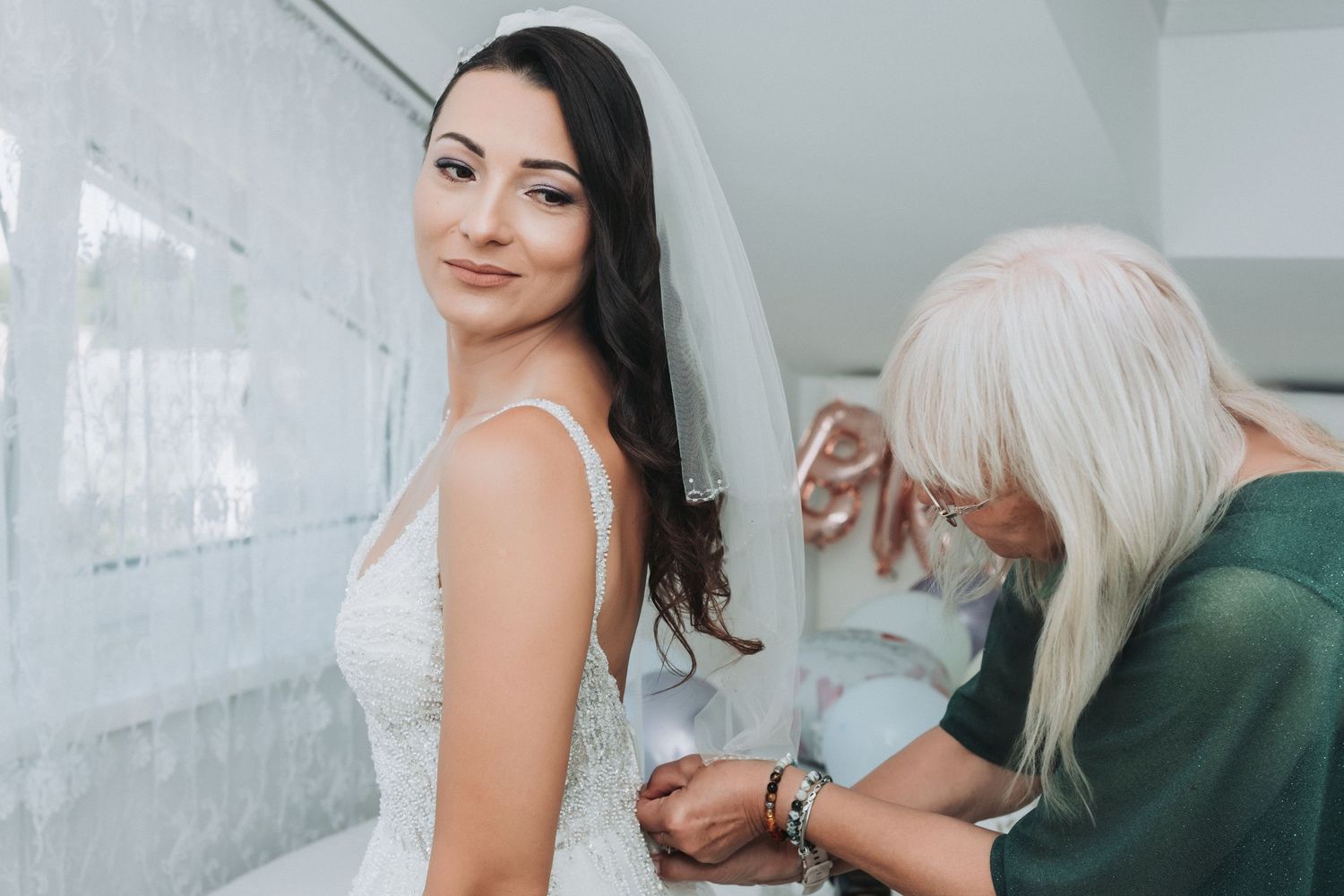 Final dress fitting adjustments being made to wedding gown.