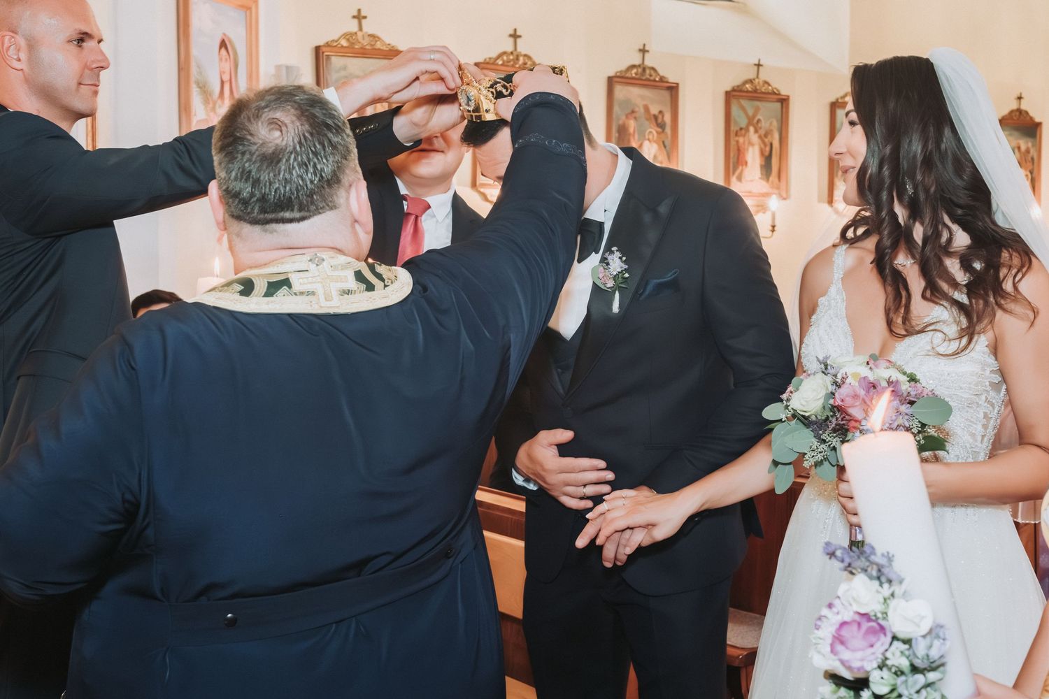 Priest blessing the couple during a traditional church wedding ceremony.