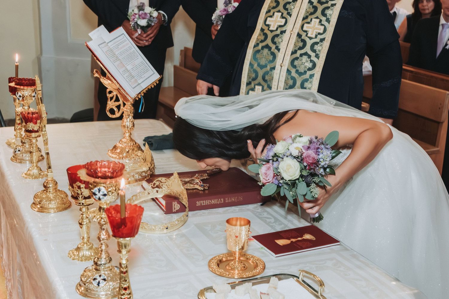 Wedding altar decorated with golden candlesticks and religious items for ceremony.