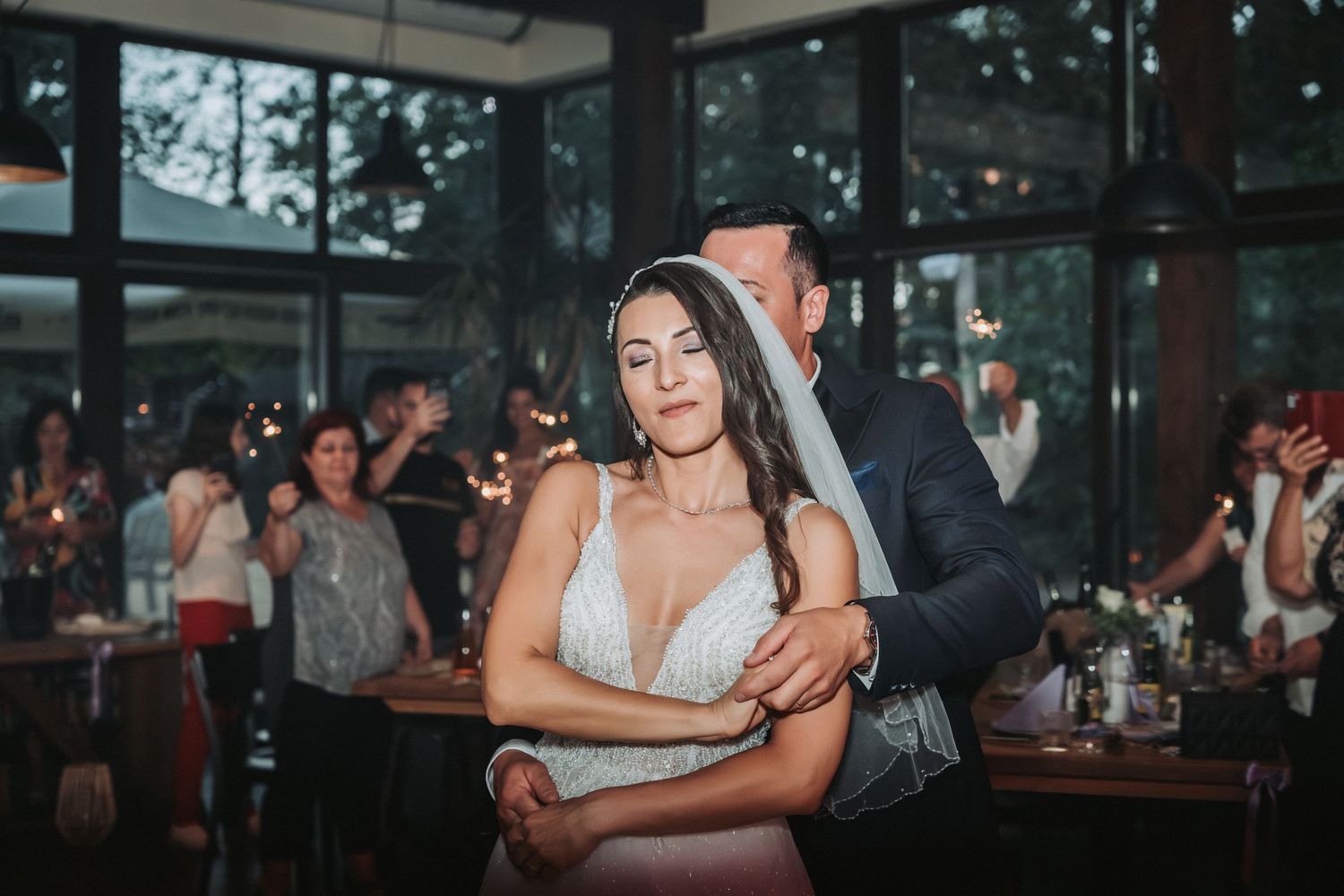 A couple shares an intimate dance moment at their wedding reception.
