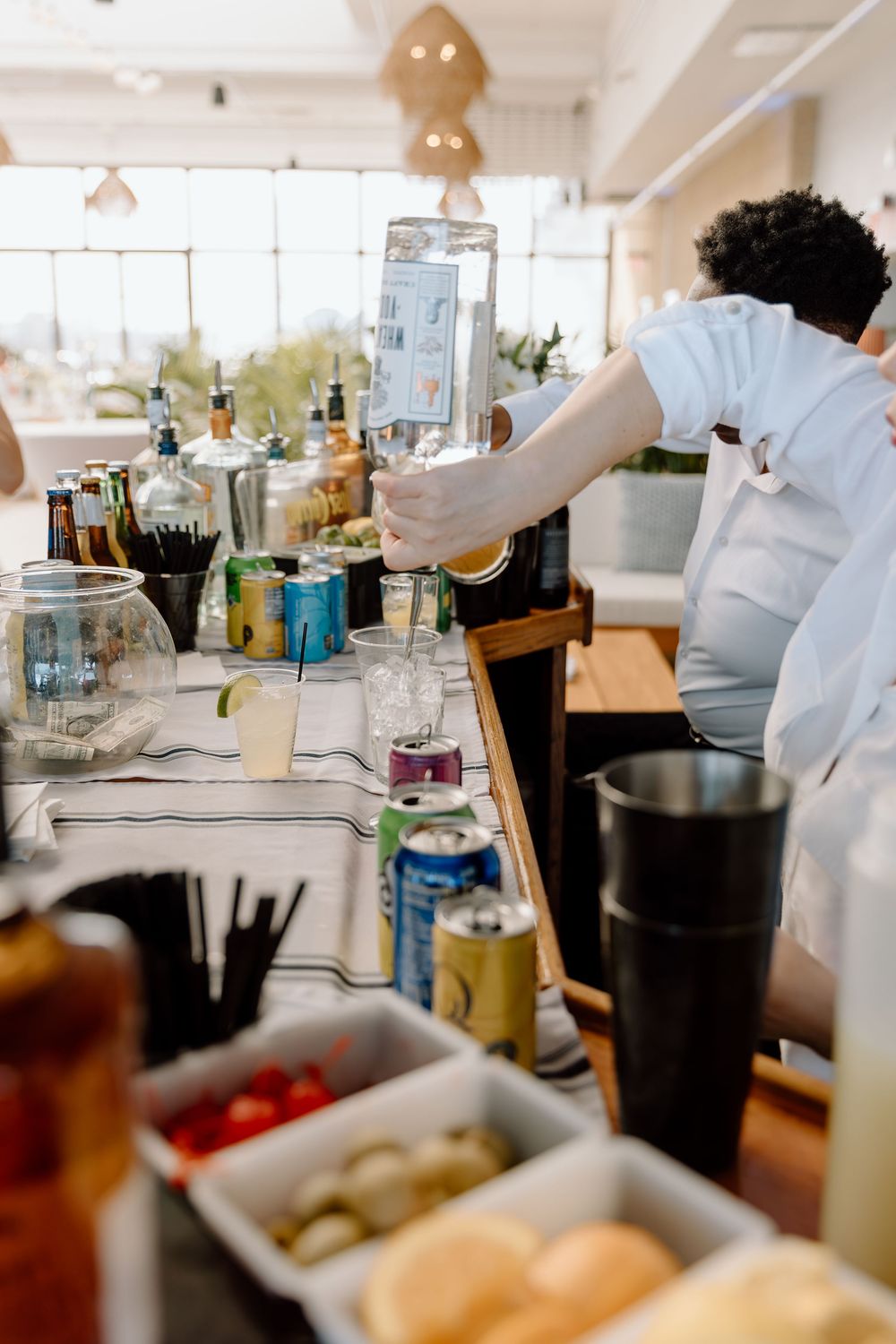 Close-up shot of various plates and drinks being served at an indoor dining event.