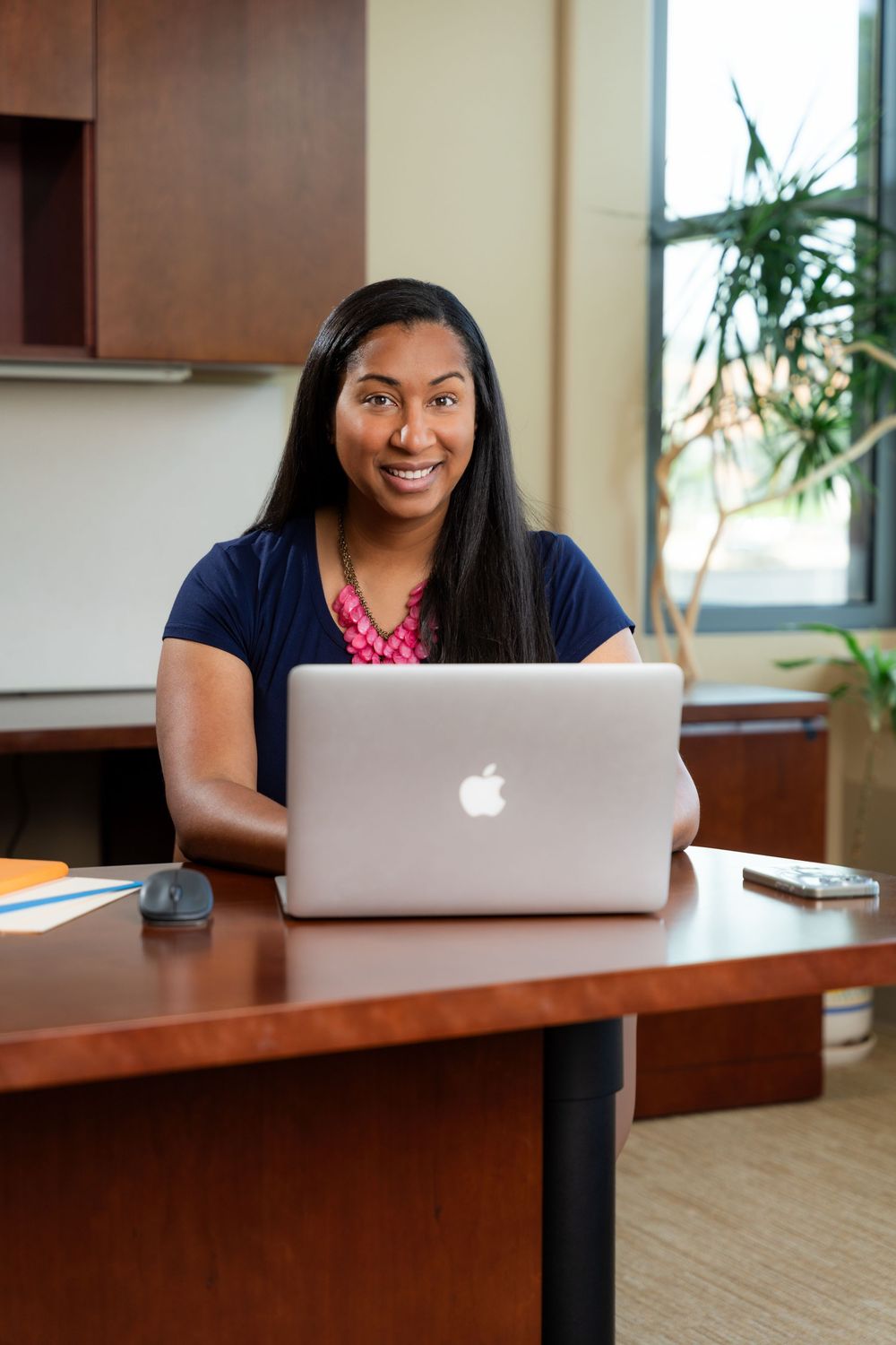 Environmental portrait of a virtual assistant sitting in an office ready to help you succeed.
