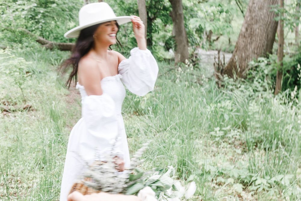 A series of photos showing someone in a white flowing dress twirling joyfully in a lush green forest setting.