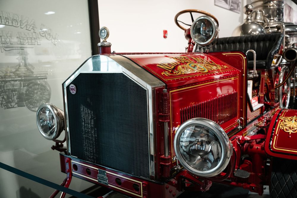 Multiple red vintage motorcycles are displayed in a row, showcasing their classic designs and chrome detailing.