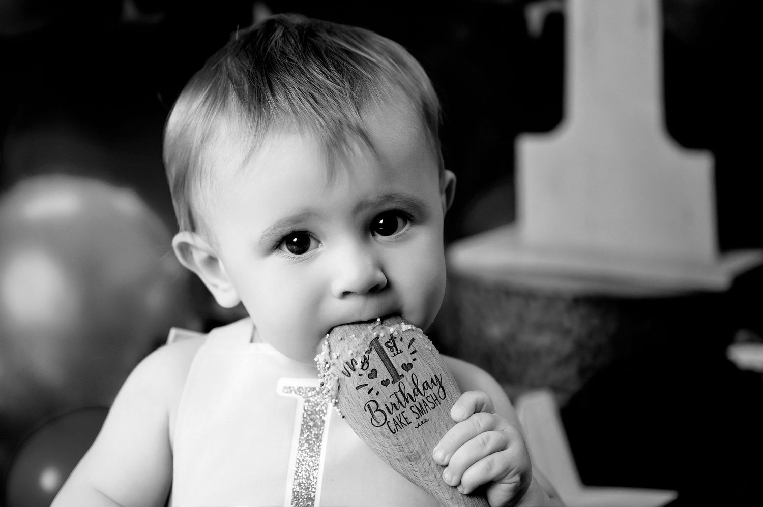 A black and white portrait featuring party decorations and festive elements.