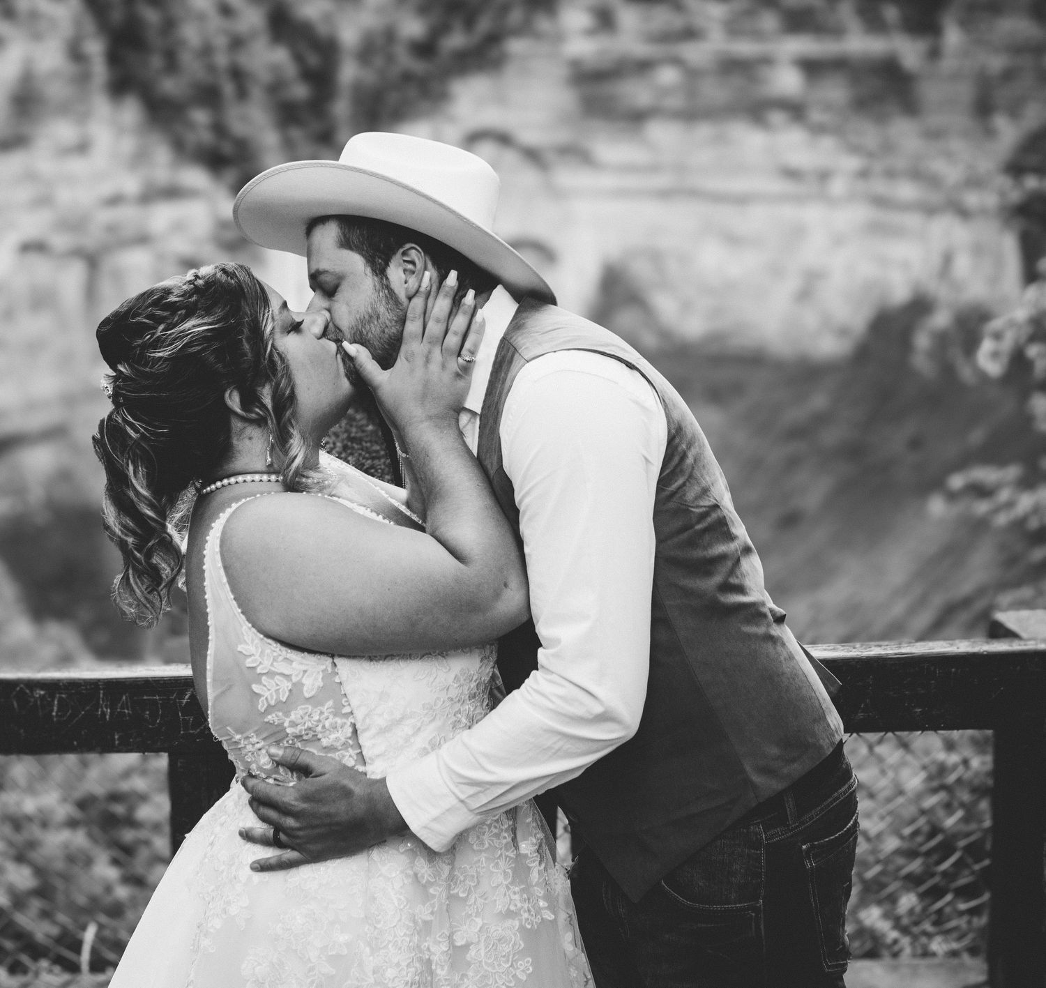 Romantic black and white wedding portrait showing newlyweds sharing an intimate moment.