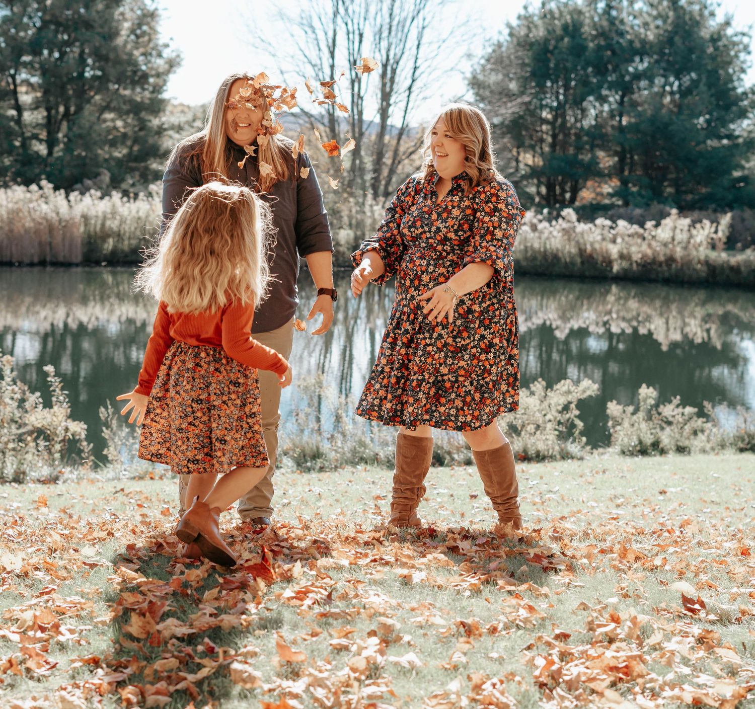 Autumn scene with small legs in matching leopard print outfits walking through fallen orange leaves.