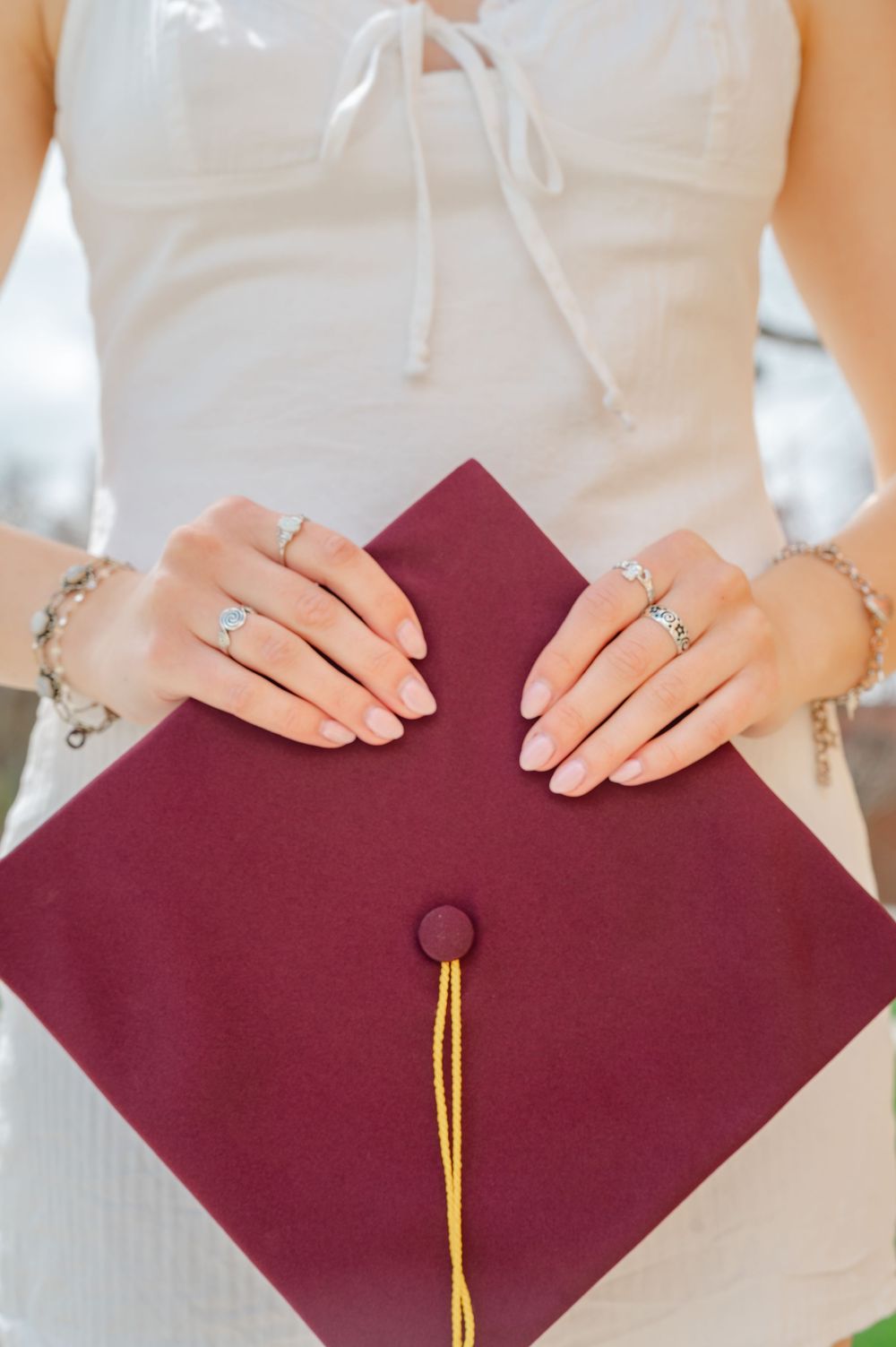 detail shot of grad holding her cap