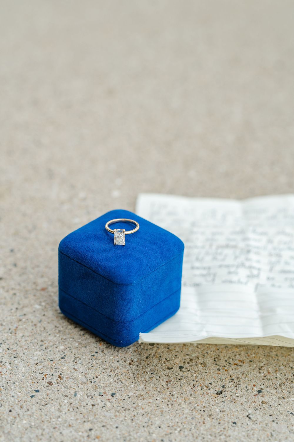 detail shot of ring, box, and note