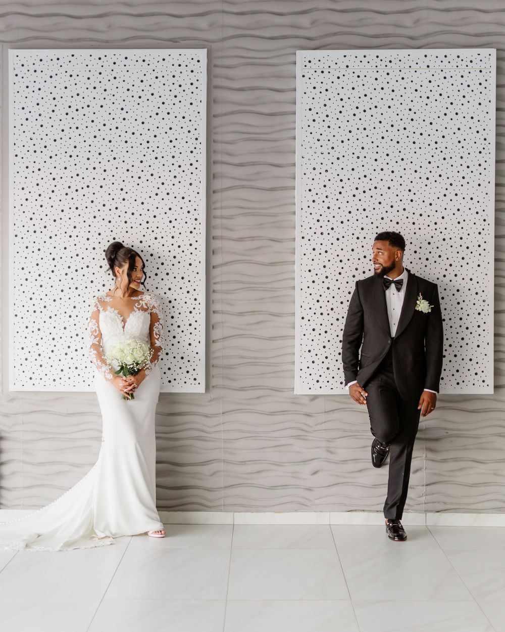 Stylish bride and groom pose indoors at Galu Seaside in Larnaca, captured by a professional wedding photographer in a modern, elegant