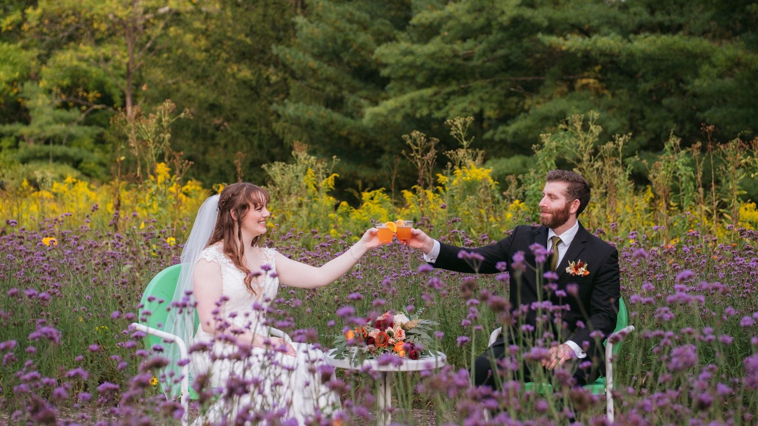 A newlywed couple shares a playful moment while enjoying a slice of wedding cake at their reception.
