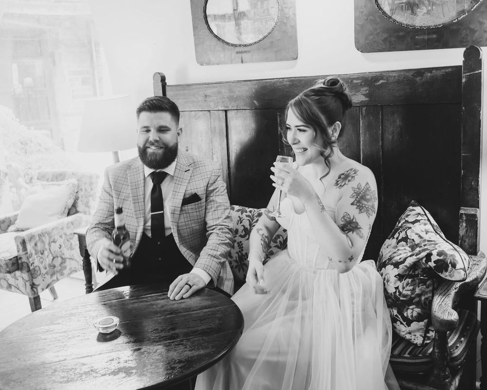 Bride and groom in the bar at Holdsworth House before the confetti line