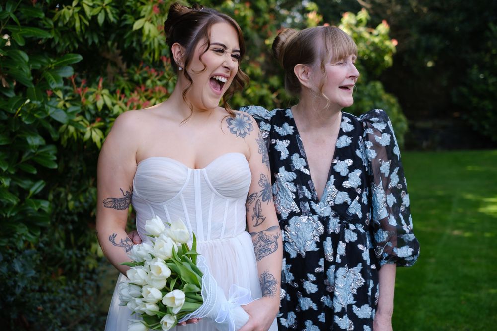 Bride with her mum, laughing in the grounds at Holdsworth House