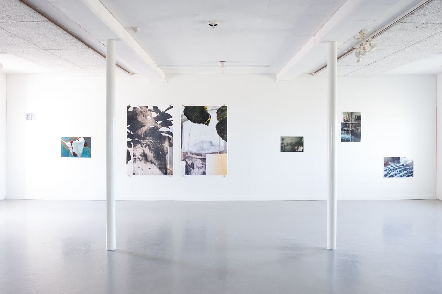 Multiple prints of different sizes pinned to a wall at Hå gamle prestegard, Sept–Nov 2022 solo exhibition.
