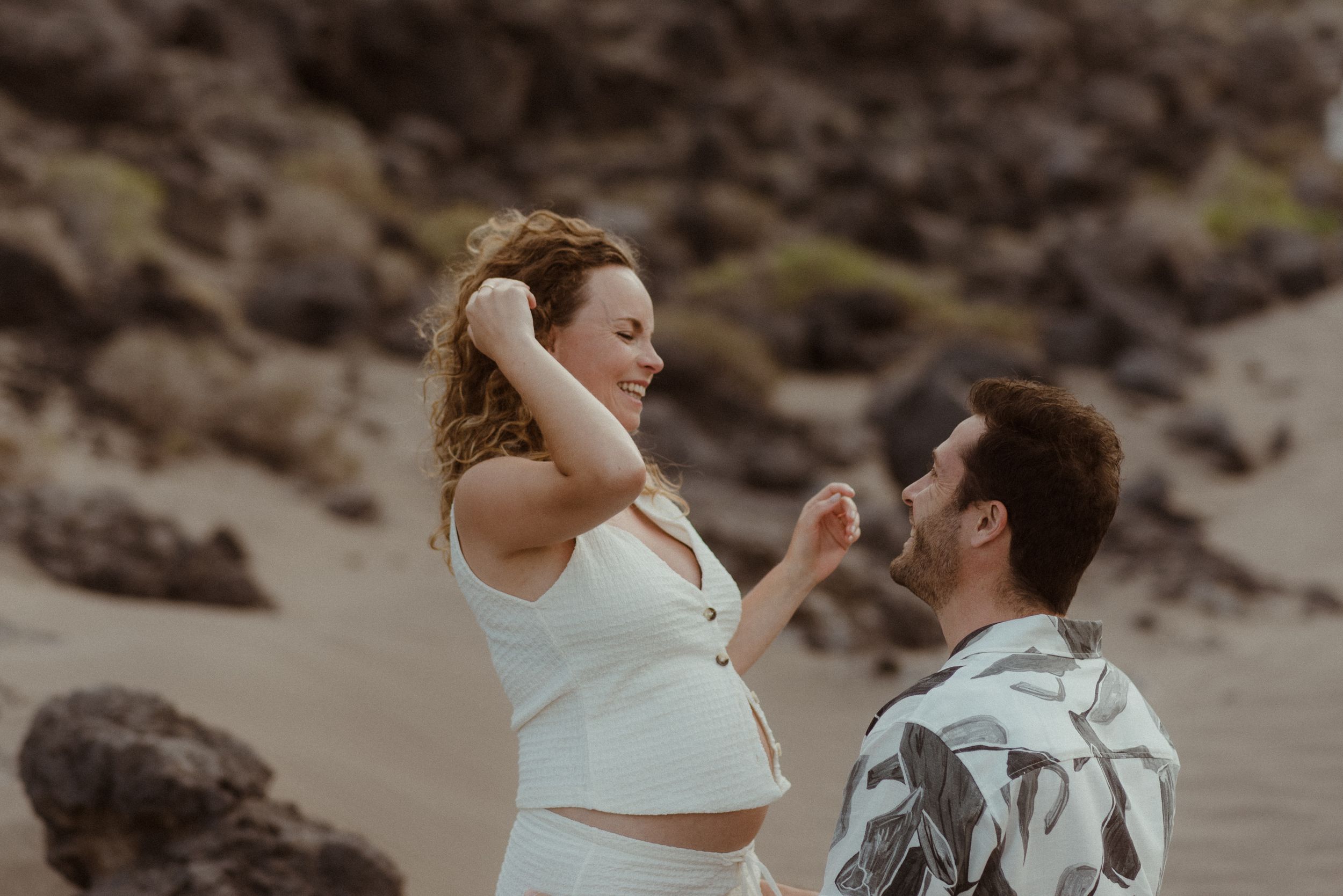 Surprise proposal on a rocky beach at sunset in El Médano, Tenerife.