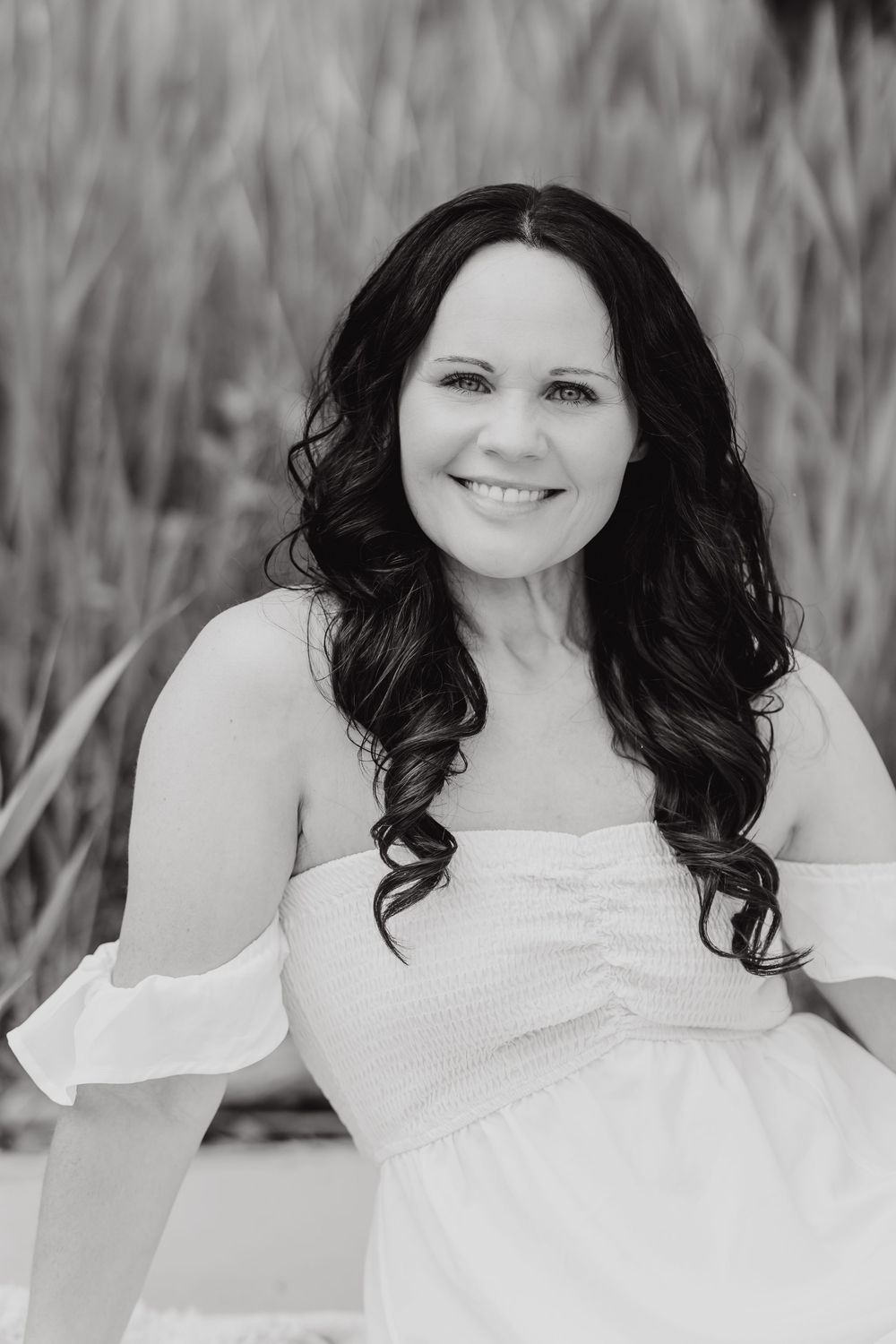 Black and white photo series showing person wearing white outfit against blurred outdoor background.