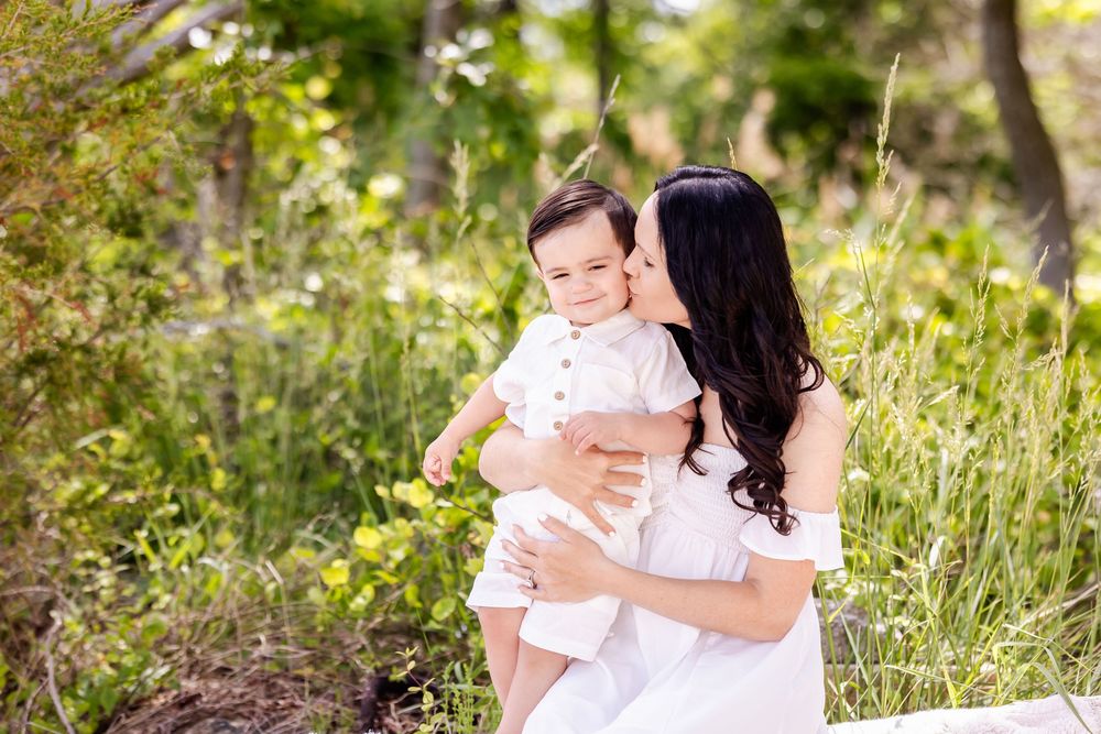 Collection of candid outdoor family photos showing parent and child in matching white outfits against natural backdrop.