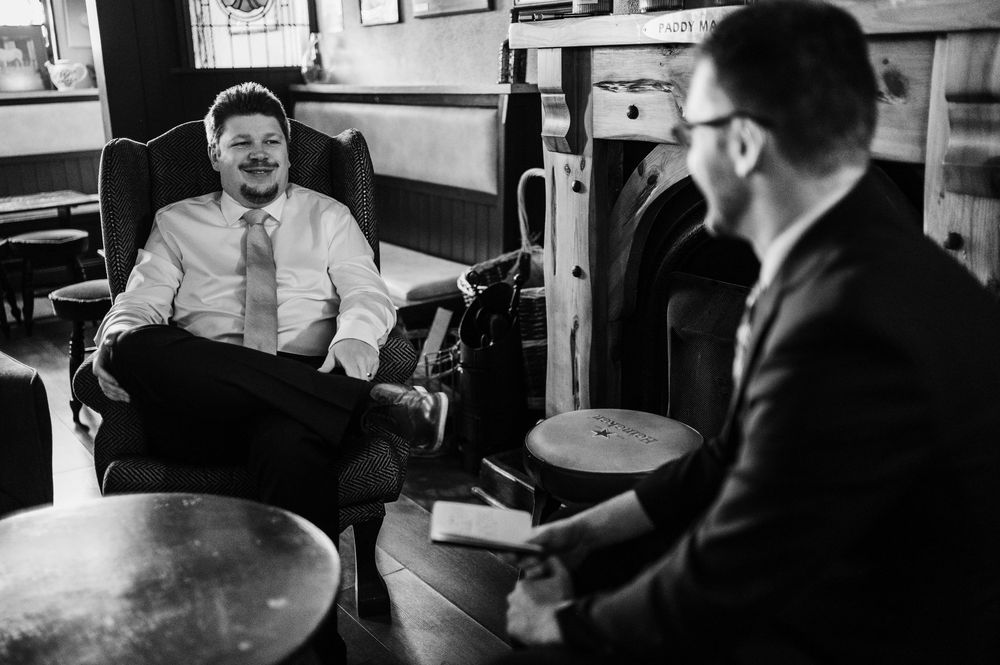 People sitting and talking in an office setting during what appears to be a business meeting or interview.