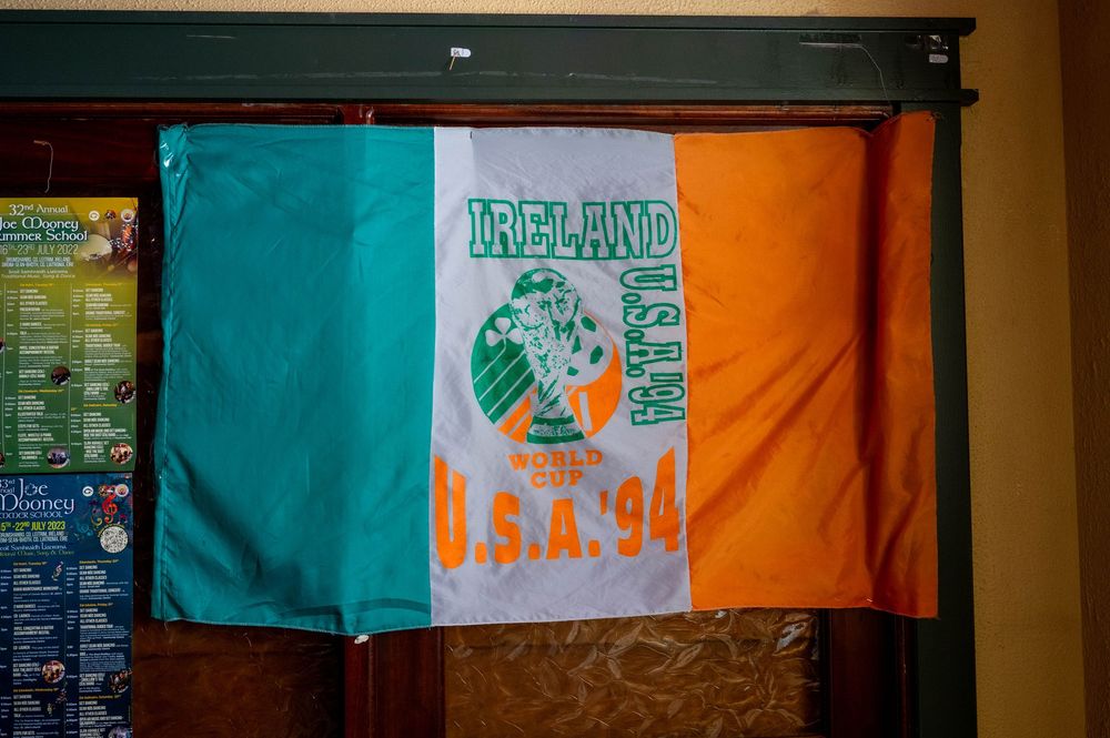 Irish flag with World Cup USA 94 logo displayed on wall featuring green, white and orange tri-color design.