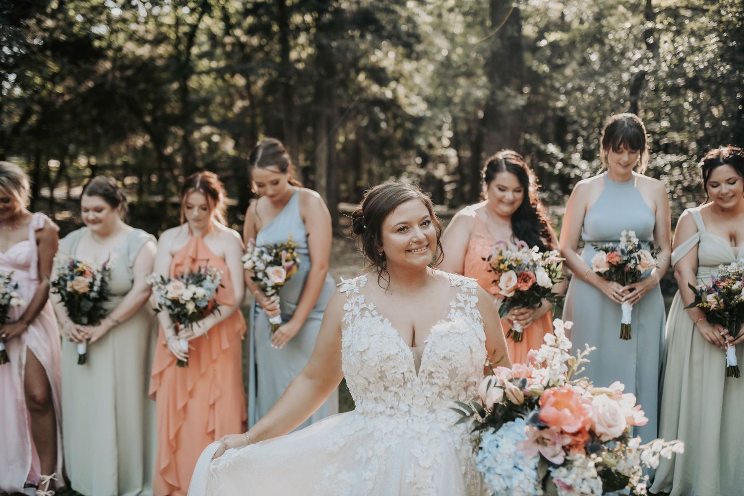Elegant bridal party standing in a line with soft natural light