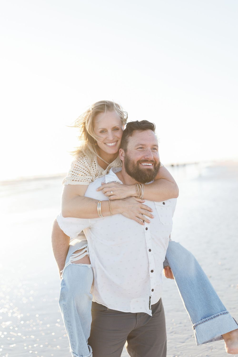 a couple joyful after saying yes to the proposal on siesta key beach