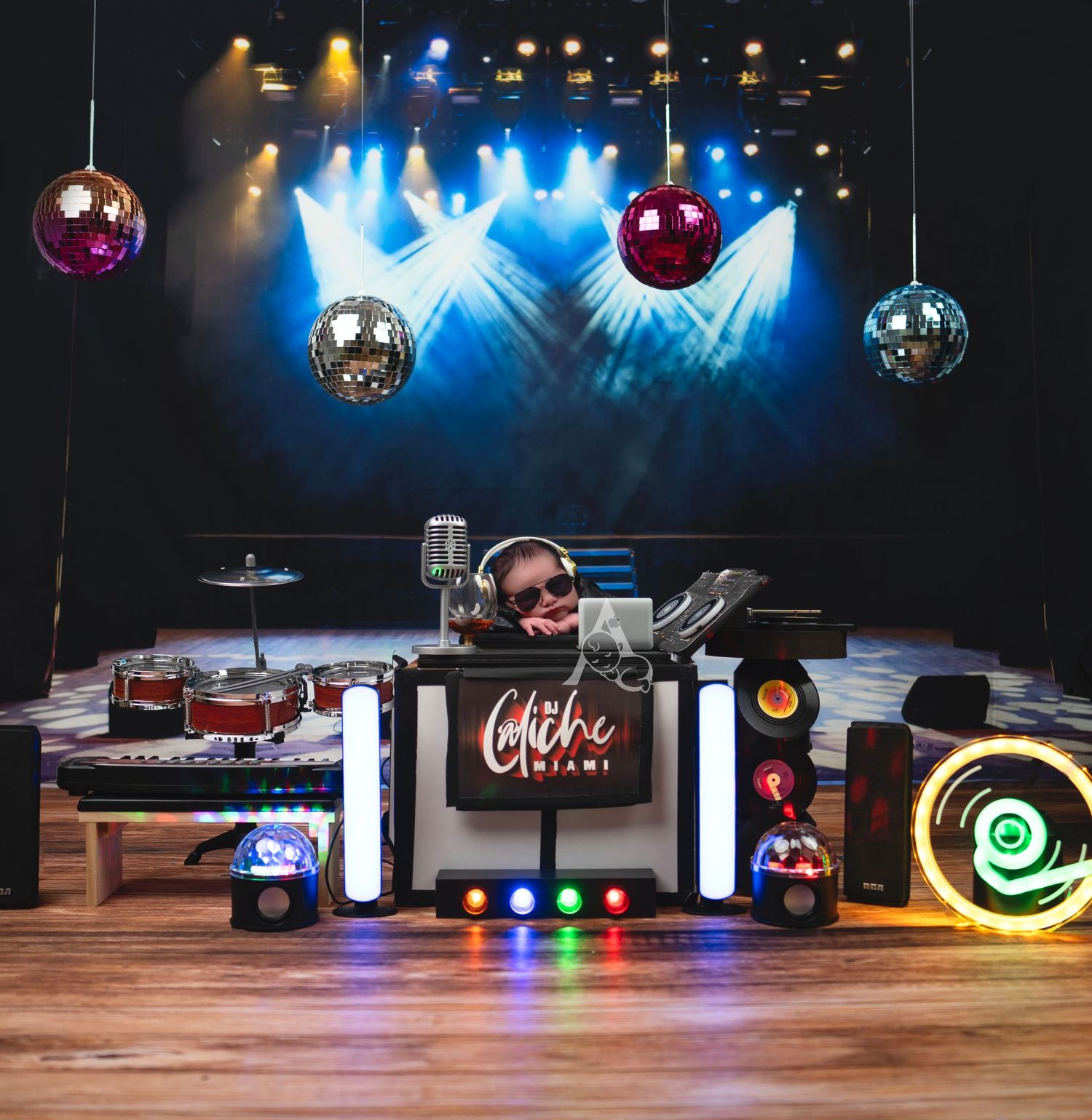 DJ setup with disco balls and blue stage lighting at night club venue.