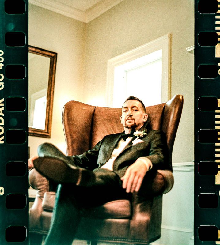 Film photo Groom in Brown chair, Christ First Church Fox Chapel Pittsburgh PA 35mm Film Wedding Photo.