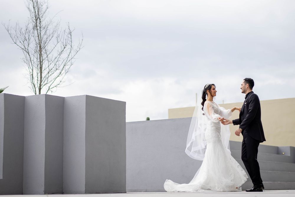 Modern minimalist wedding portrait with geometric walls creating artistic composition.