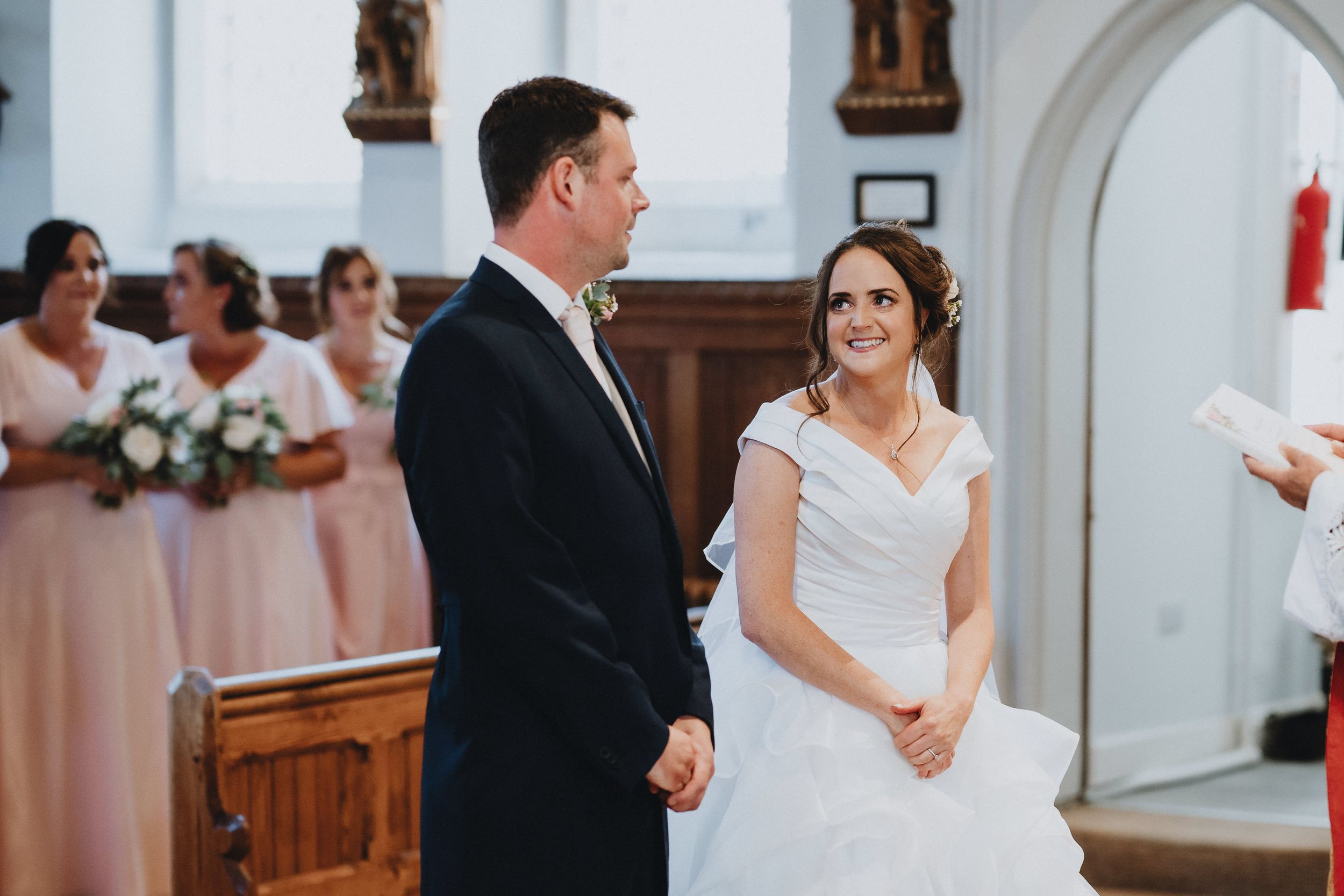 A couple stands together at the altar during their traditional church wedding ceremony.