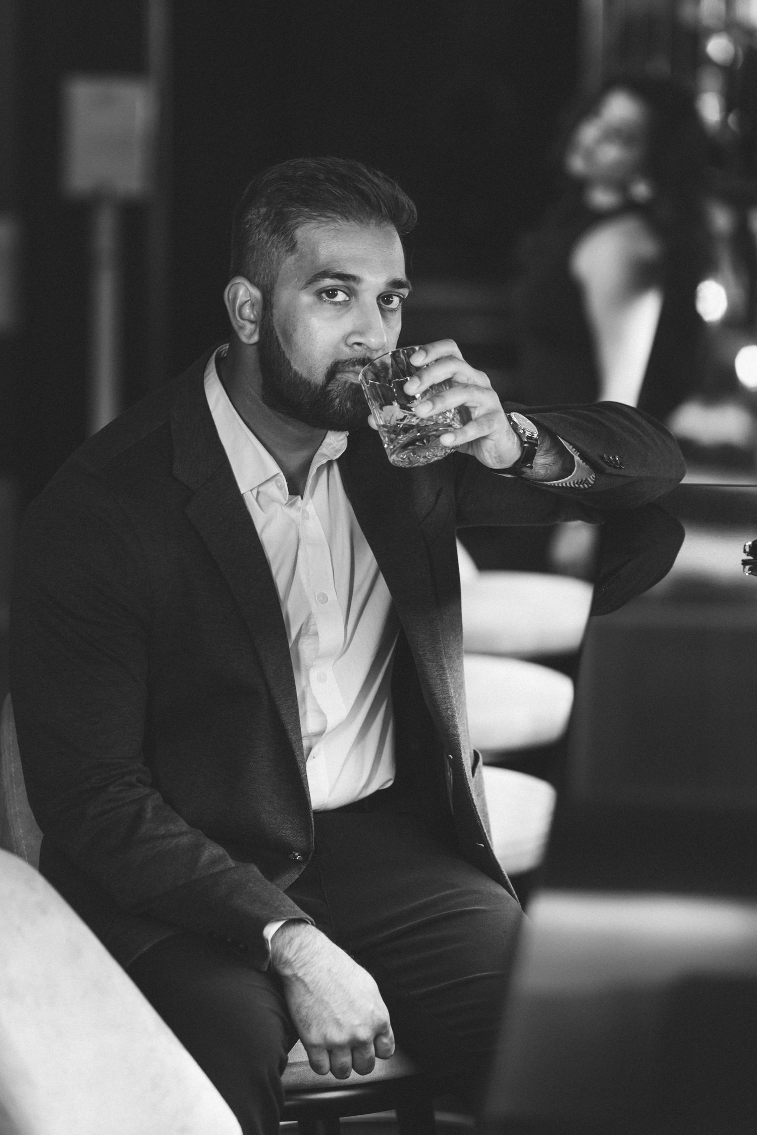 Cinematic couple portrait at the stylish Maxime Hotel bar in Lisbon during their engagement session.