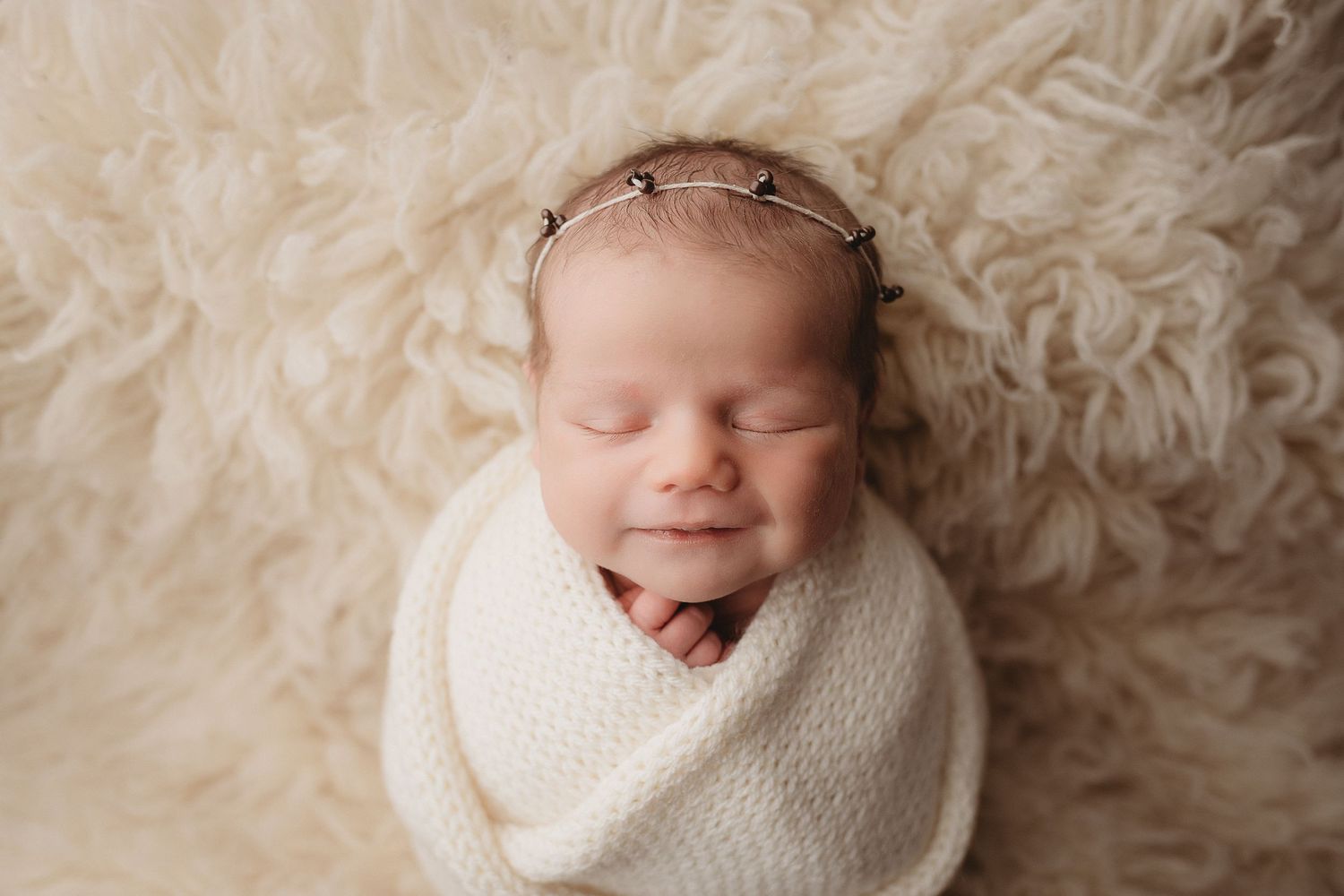 Professional photo of a newborn baby smiling