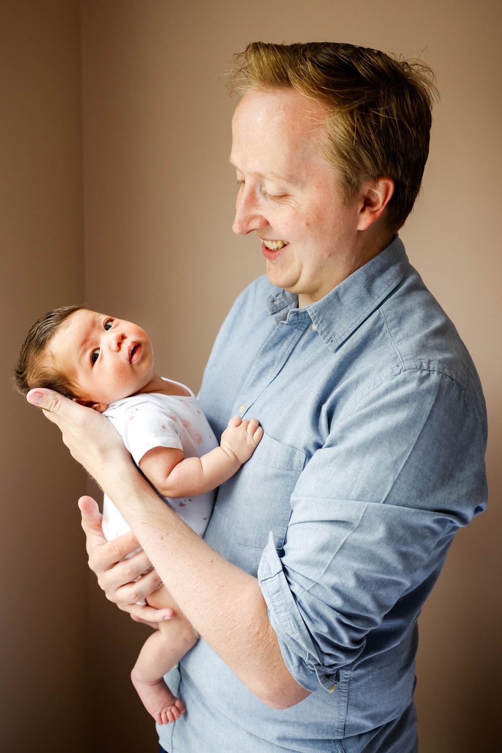 dad holding baby girl in his arms