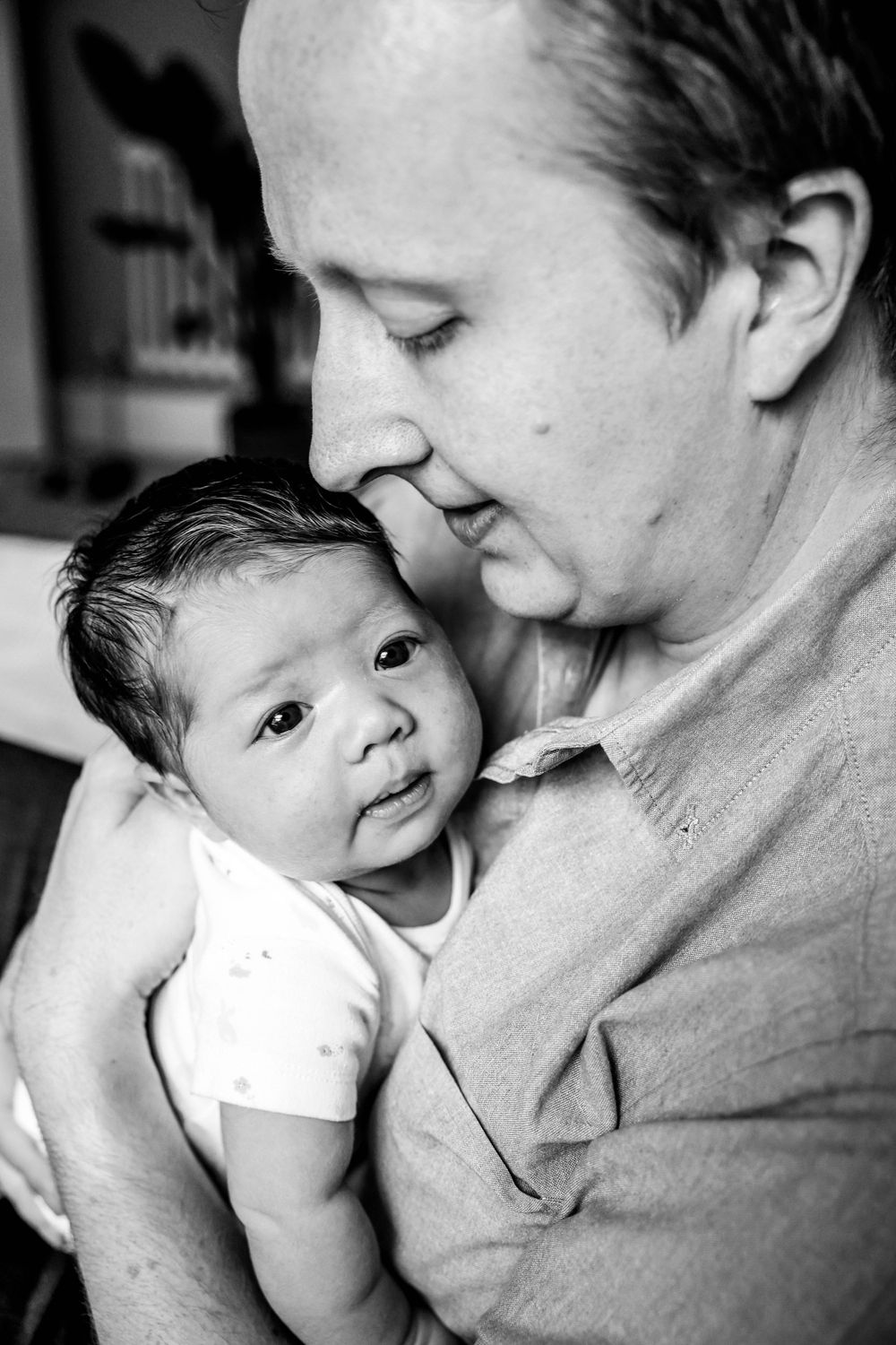 dad holding baby daughter close to his chest