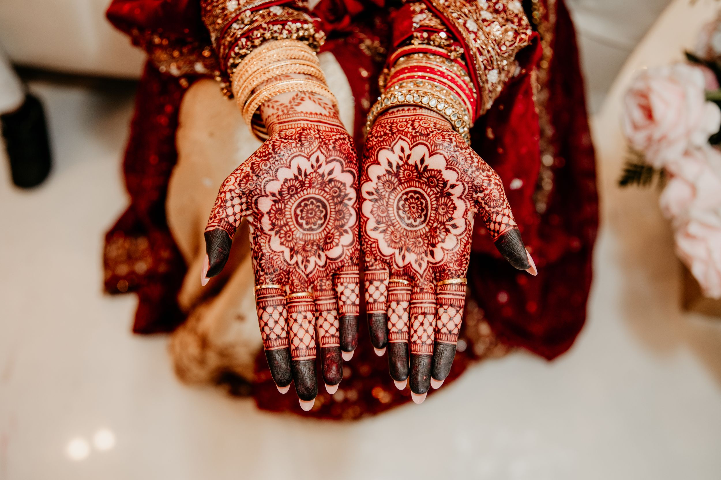 Traditional henna mehndi designs decorating bride's palms for wedding ceremony.