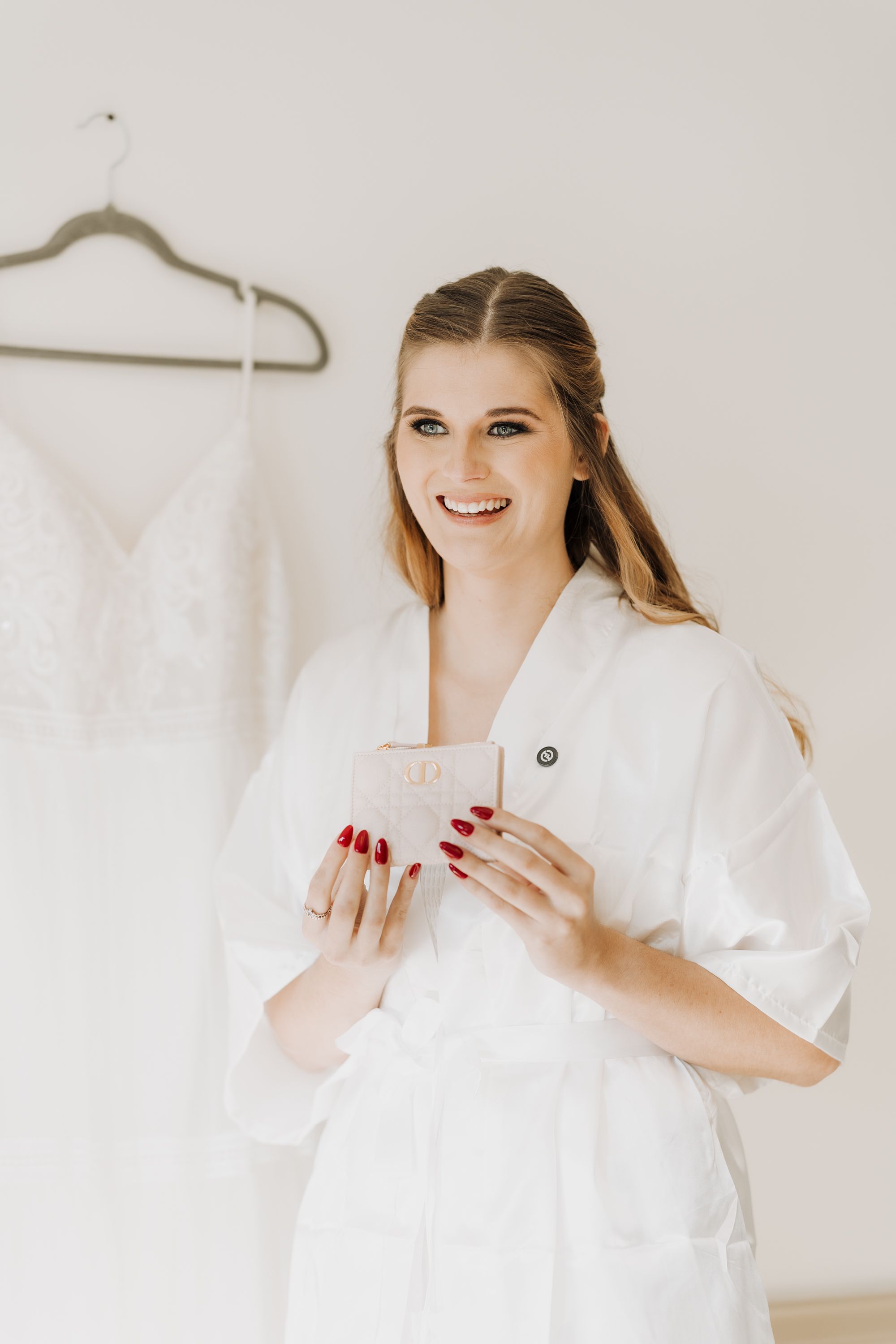 Getting ready scene with white robe and natural morning light.