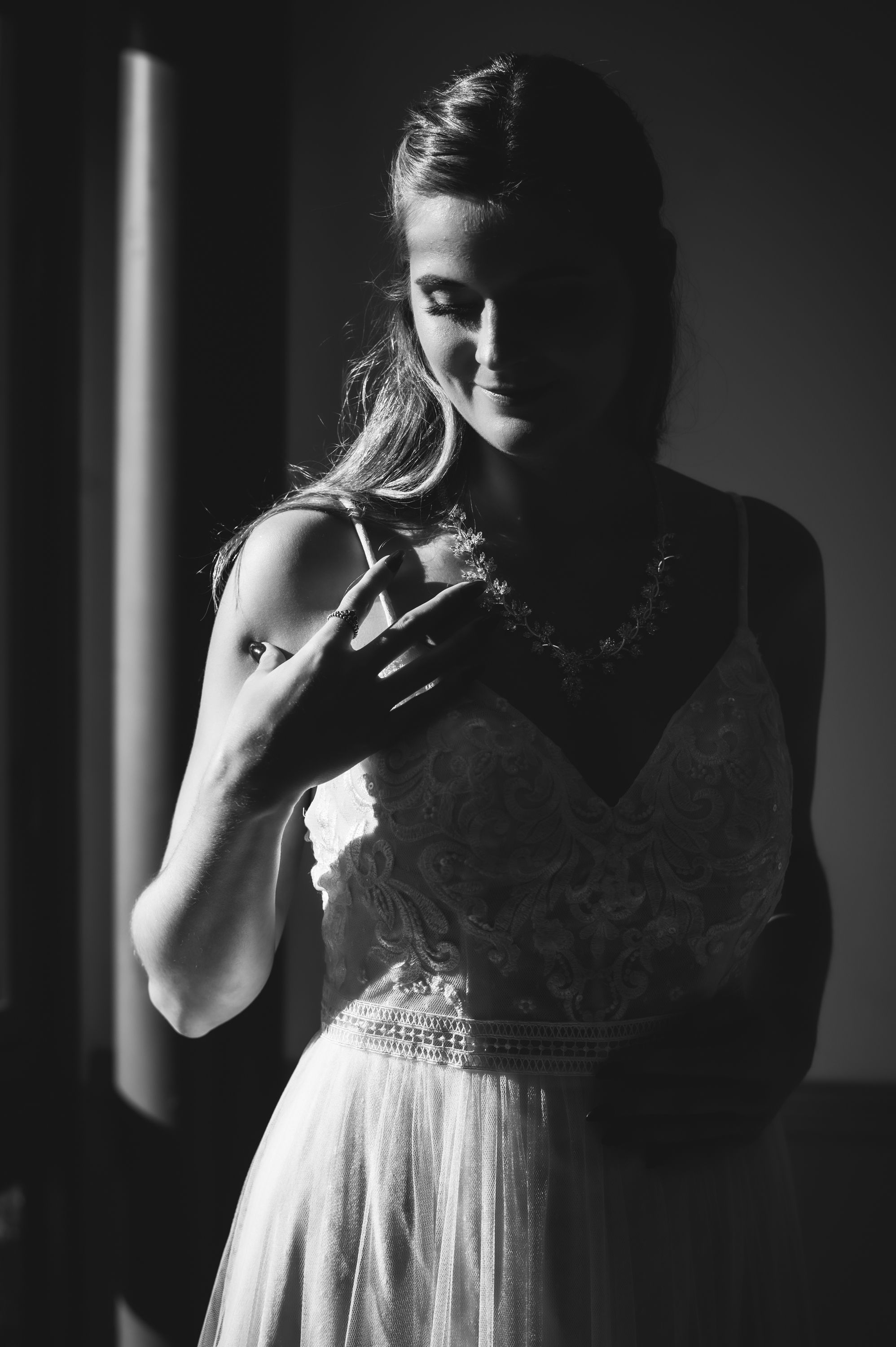 Dramatic black and white bridal portrait with moody lighting.
