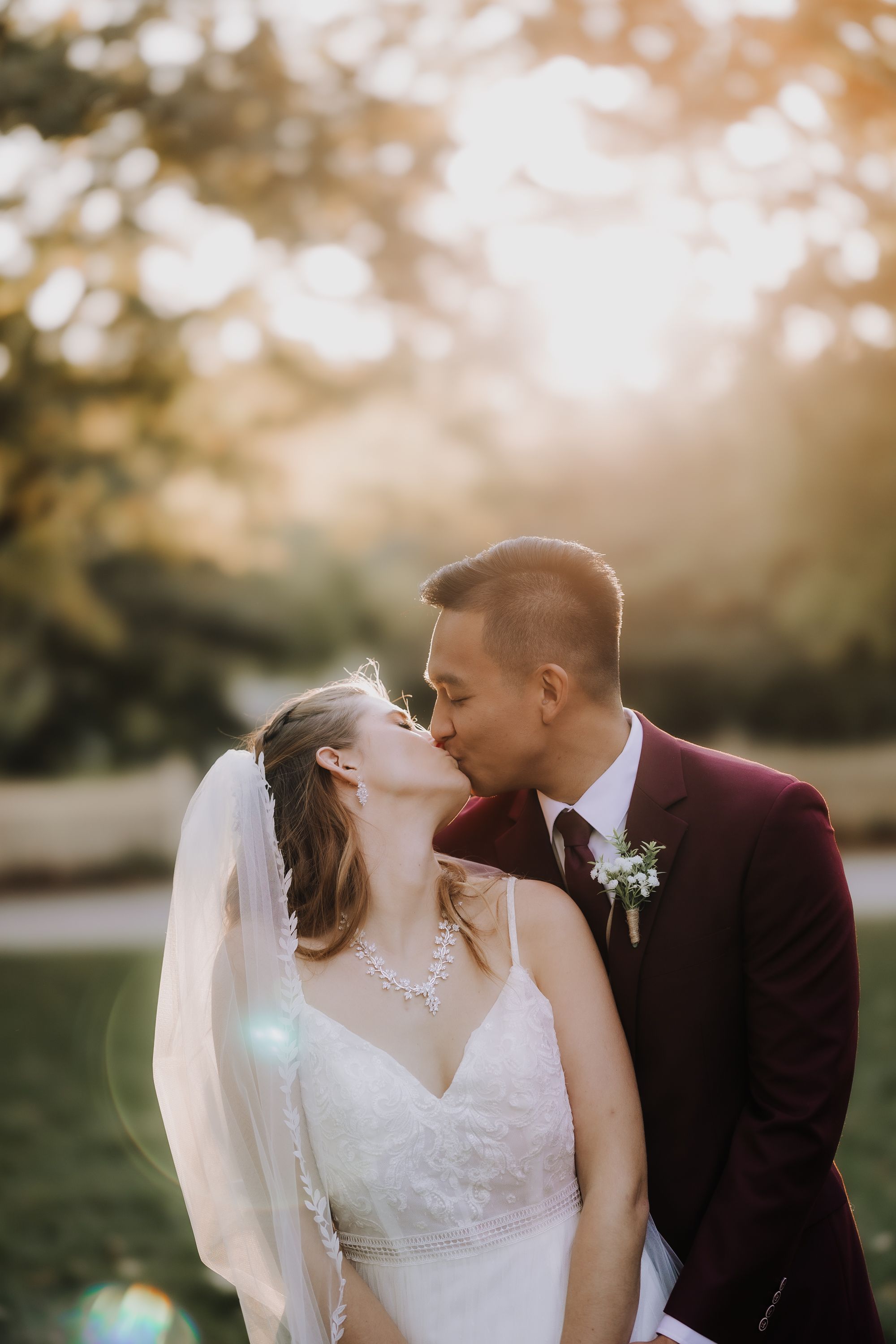 Romantic sunset wedding portrait in outdoor setting.