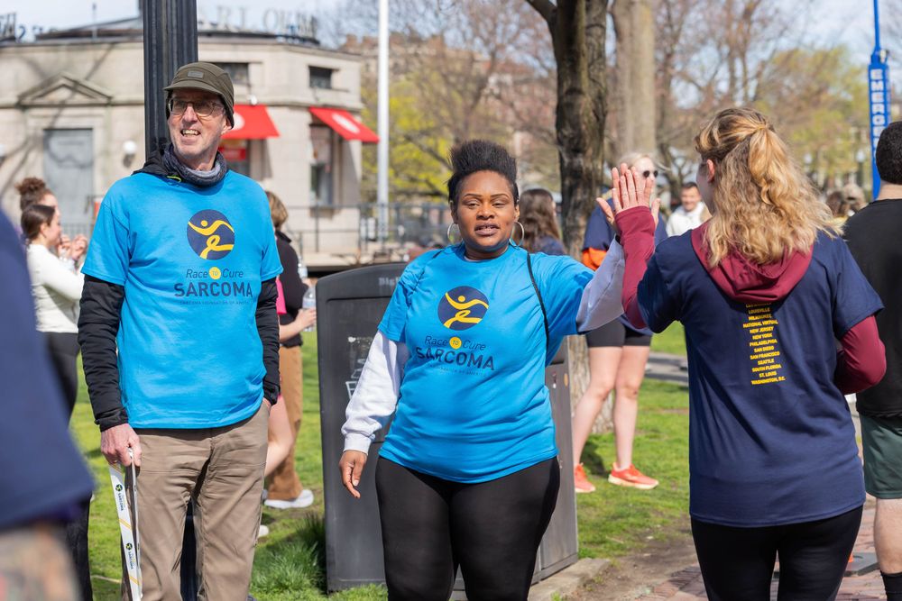 Participants wearing matching blue t-shirts at an outdoor community event.