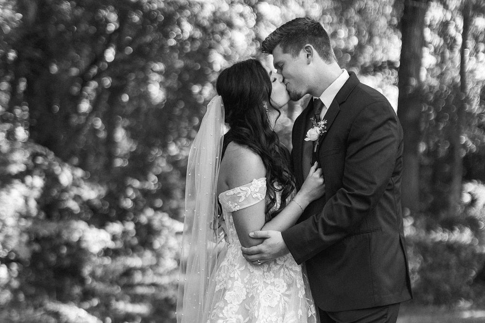 Black and white romantic wedding portrait of couple sharing an intimate moment.