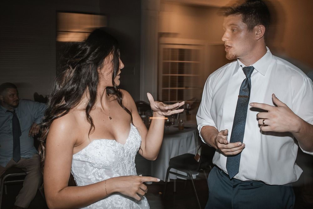 Animated conversation between guests during a lively wedding reception.