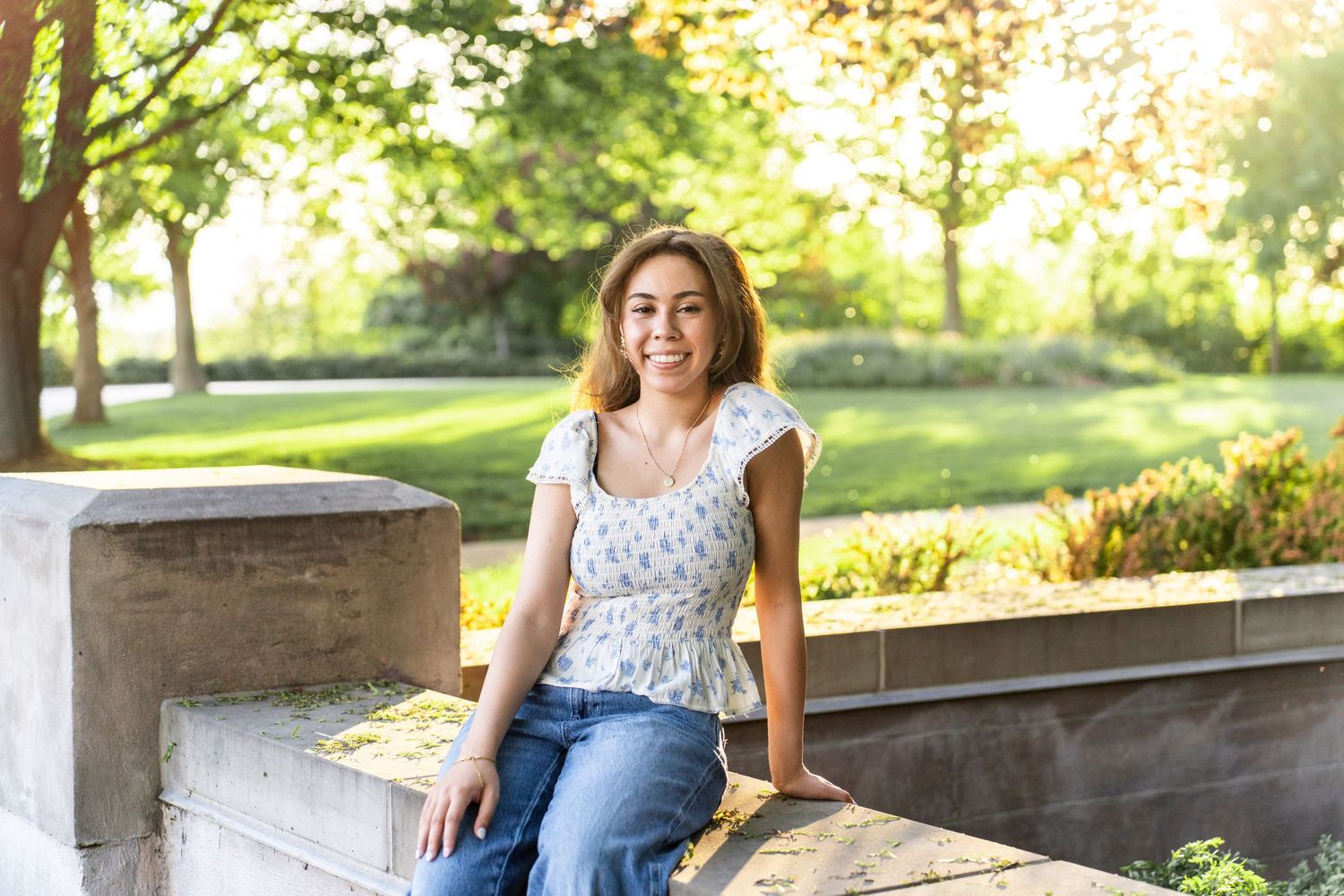 True to color graduation photo of girl sitting on bench in provo Utah.
