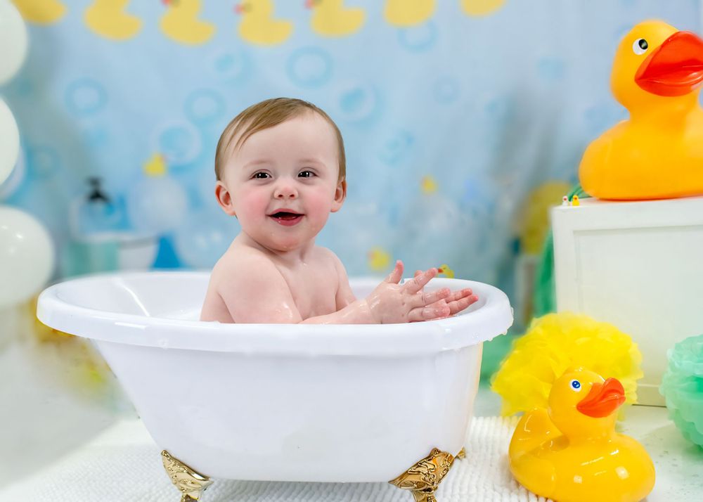 Splashing bathtime scene with rubber ducks and blue background decorations.
