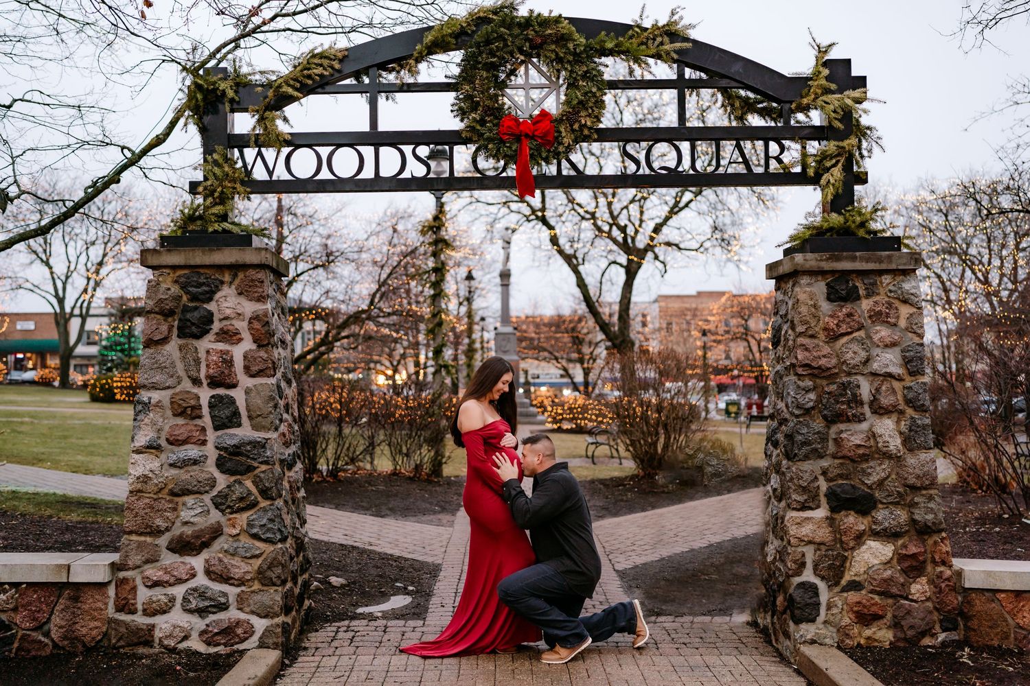 A romantic moment under a rustic stone gateway with a Christmas wreath at Woodstock, decorated for the holiday season.