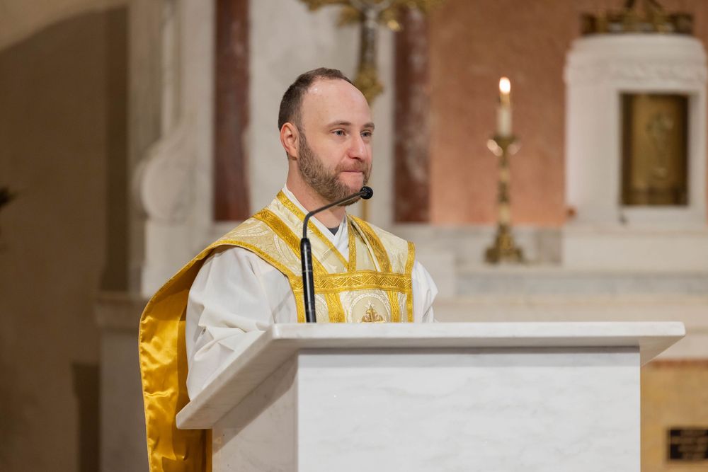 Religious ceremony at church altar with clergy in gold and white vestments.